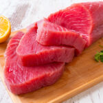 Raw tuna steak on wooden cutboard