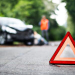 Image of a caution marker at a car accident, representing the guidance of a WV car accident lawyer on returning to work.