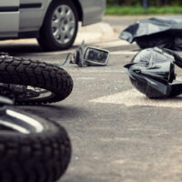 A crashed motorcycle and helmet, representing the causes of WV motorcycle accidents and impacts on riders.